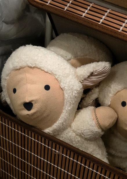 A sheep puppet in a wicker basket.